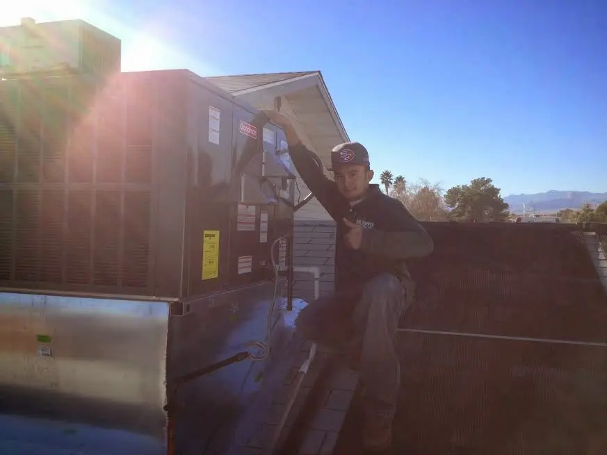 HVAC technician performing HVAC Inspection on a rooftop unit in Cleveland